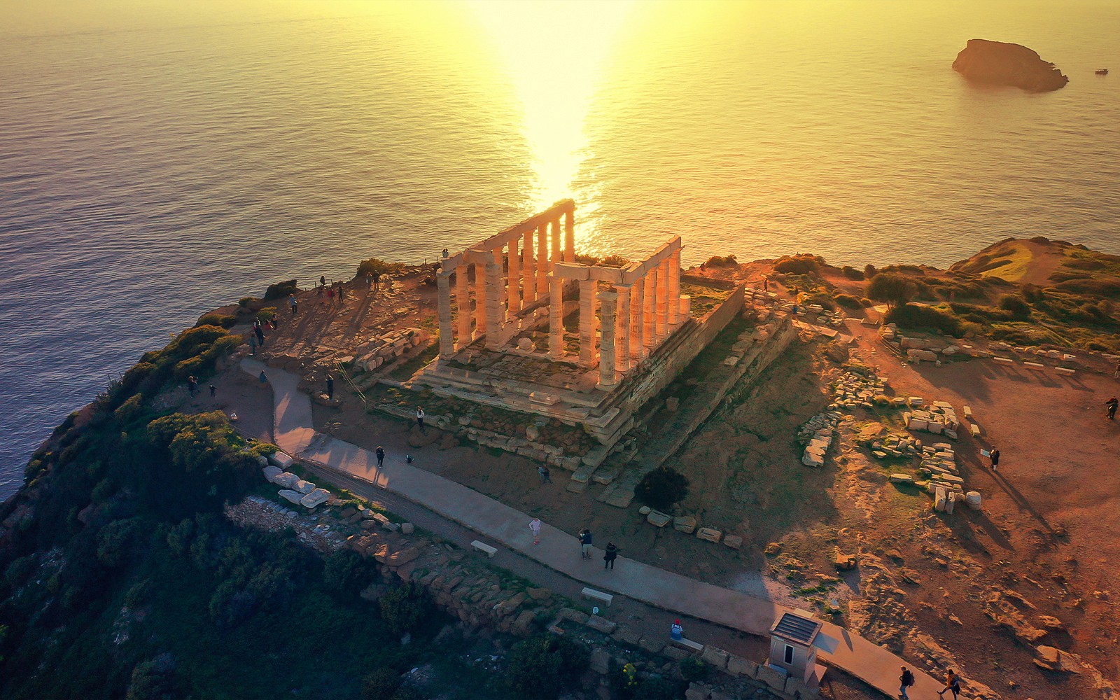 Sunset over the sea with an aerial view of the Temple of Poseidon