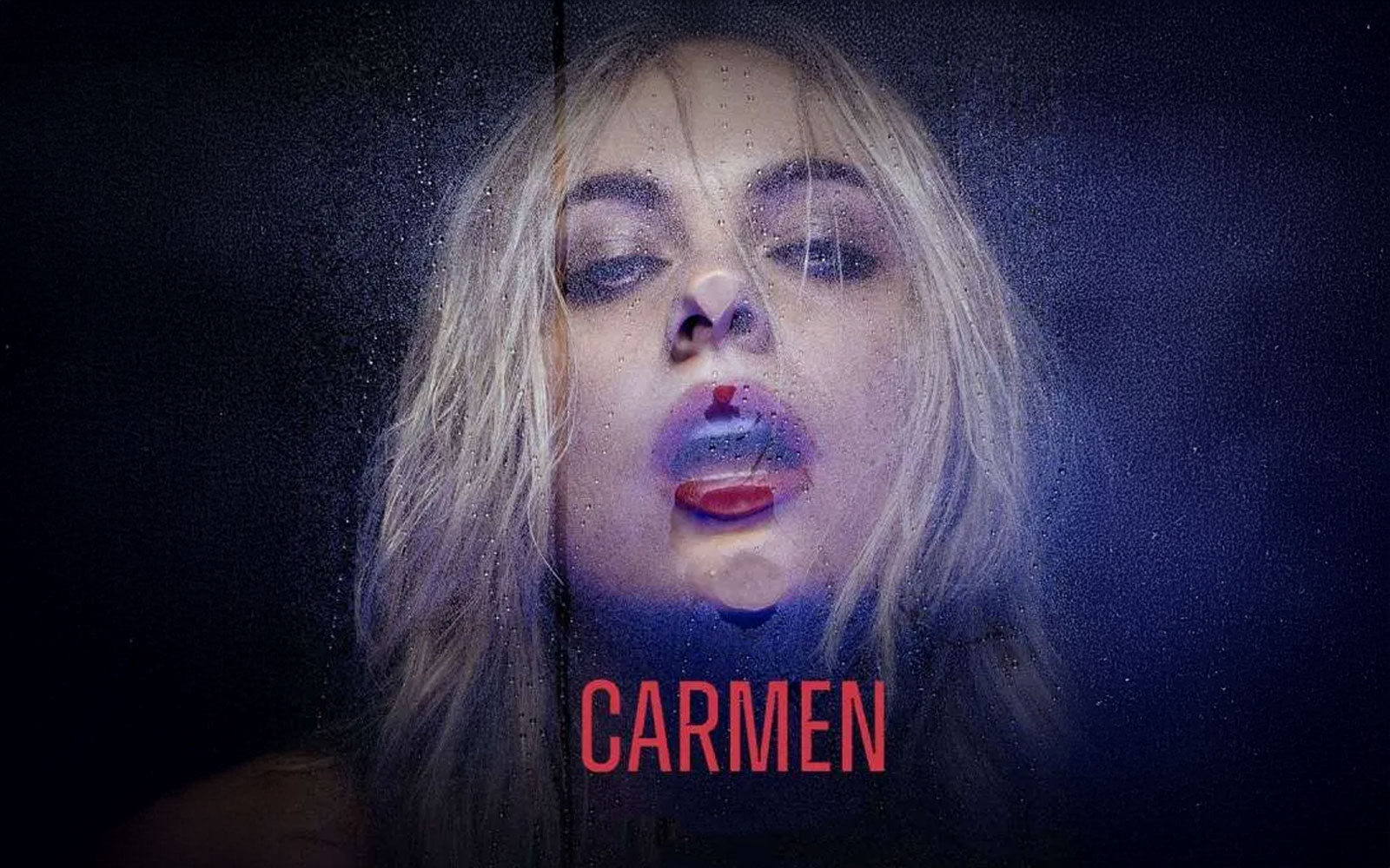 Blonde woman with wet hair and red lips behind a glass pane, text "Carmen" below.